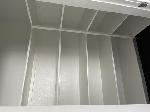 A white ceiling with a grid of panels.
