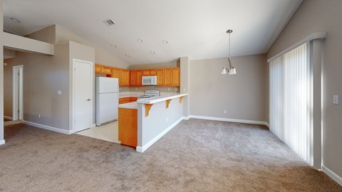 A kitchen area with a white refrigerator and a white cabinet.