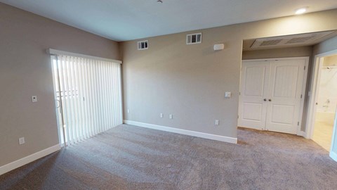 a living room with carpet and a door to a closet at Edgewater, California