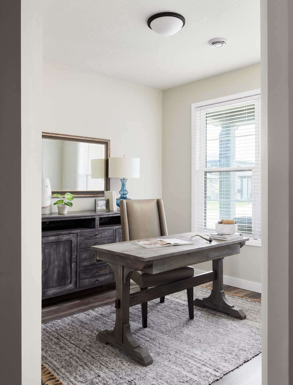 A dining room with a wooden table and chairs.