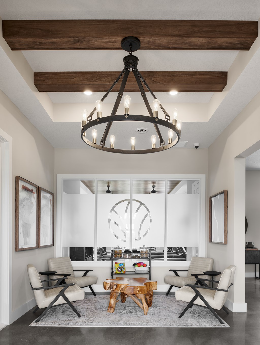 A modern living room with a large chandelier and a fireplace.