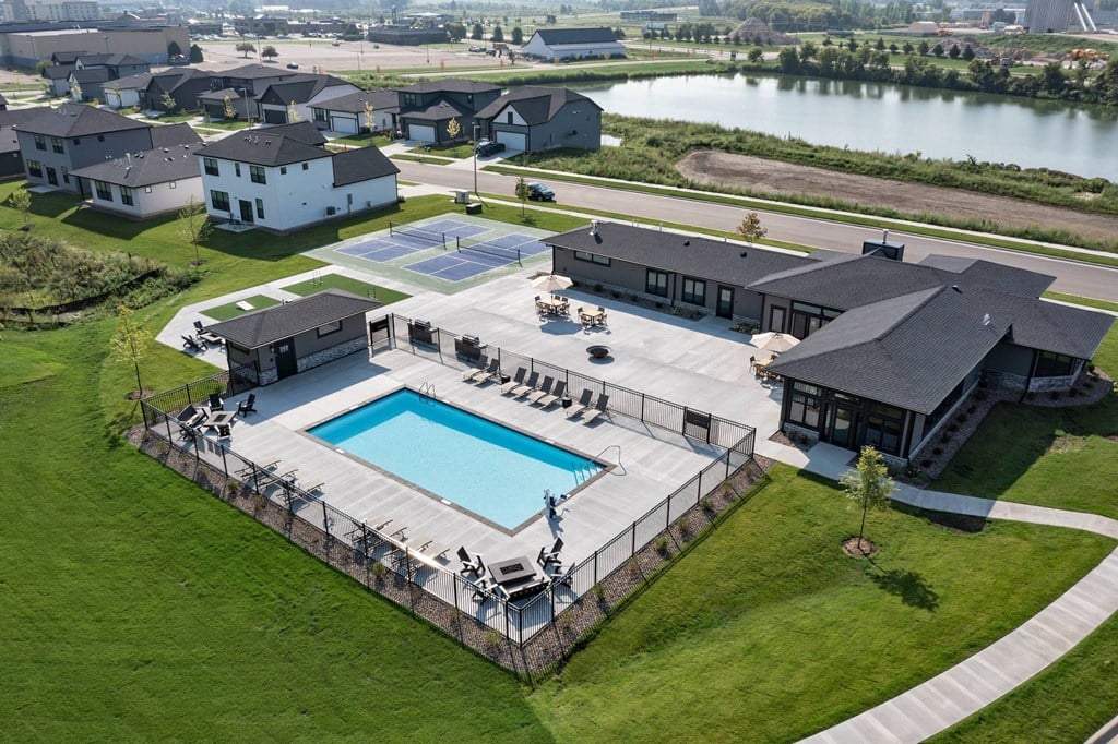 A large house with a pool in the backyard.