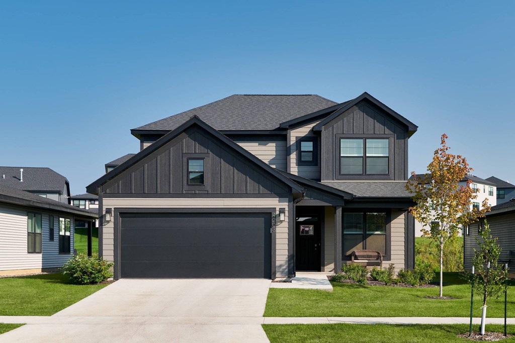 A modern house with a grey garage door.