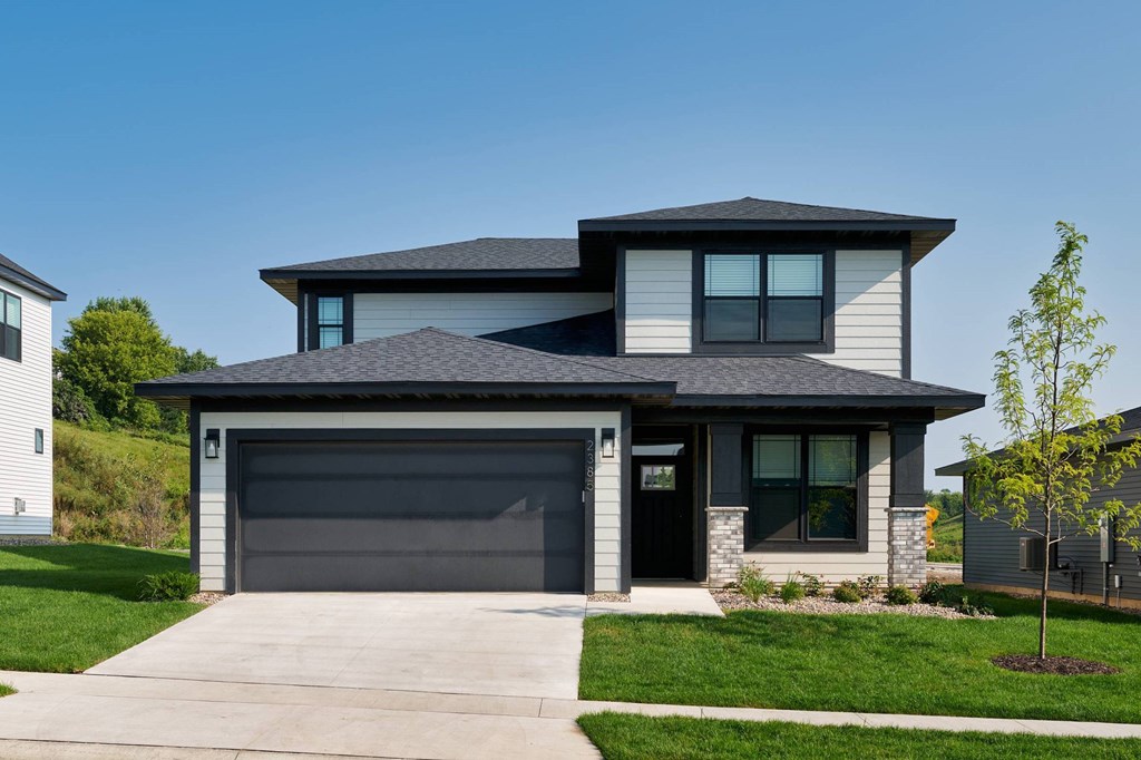 A modern house with a grey garage door.