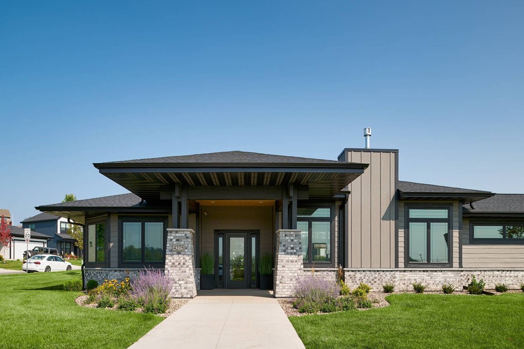 A modern house with a stone pillar in front of the entrance.
