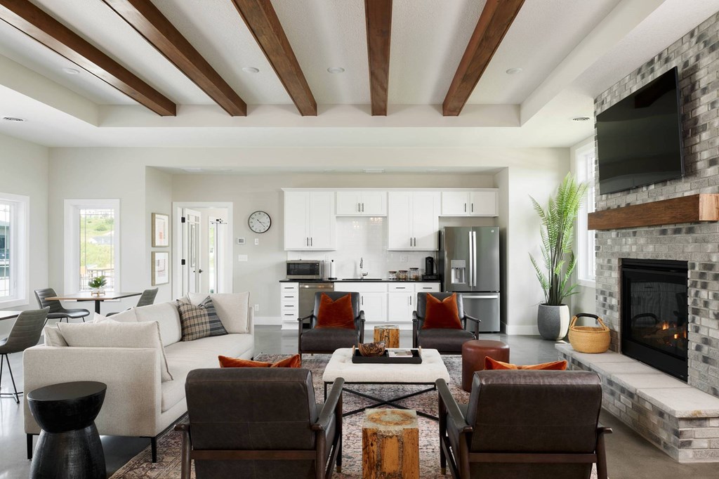 A modern living room with a fireplace and a dining area.