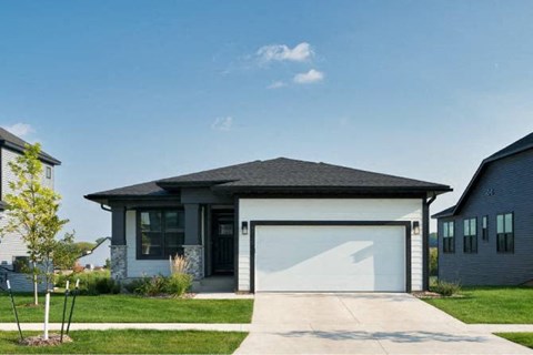a large house with a driveway and a garage door