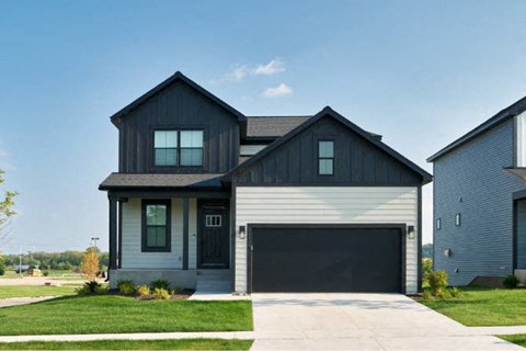 a black and white house with a garage door
