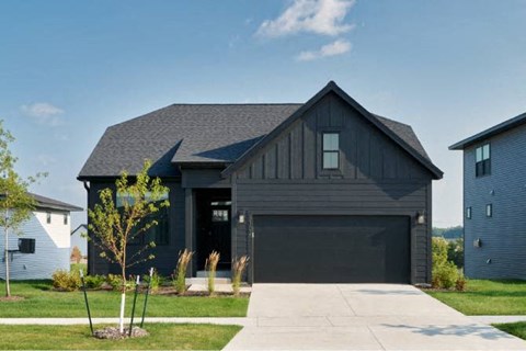 a black house with a black garage door