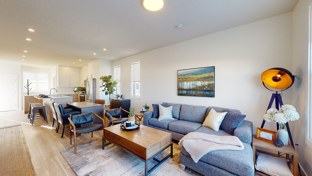 A living room with a grey couch and a wooden coffee table.