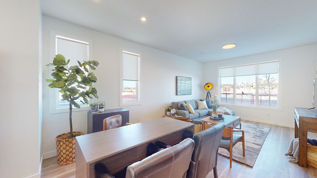 A living room with a dining table and chairs.