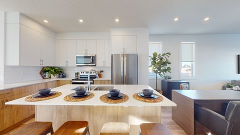 A modern kitchen with a dining table set for four.