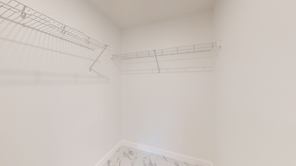 A white room with a metal rack on the wall.