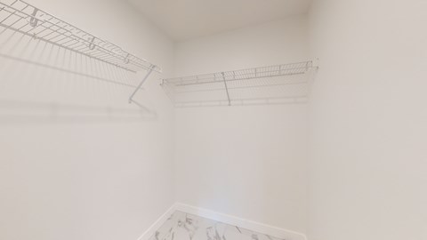 A white room with a metal rack on the wall.