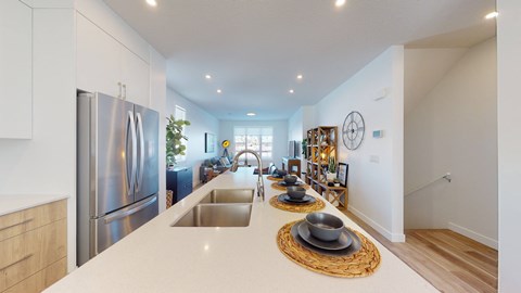 A modern kitchen with a stainless steel refrigerator and a wooden countertop.