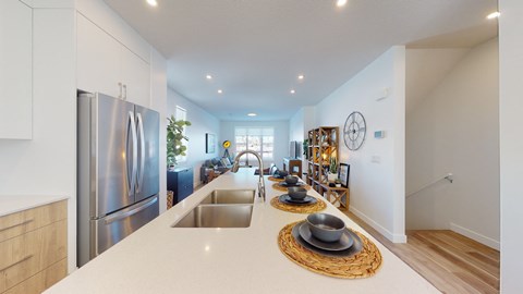 A modern kitchen with a stainless steel refrigerator and a wooden countertop.