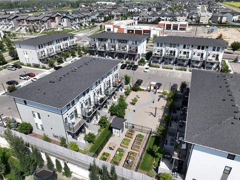 A view of a residential area with apartment buildings and a parking lot.