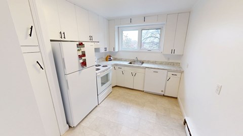 A kitchen with white appliances and cabinets.