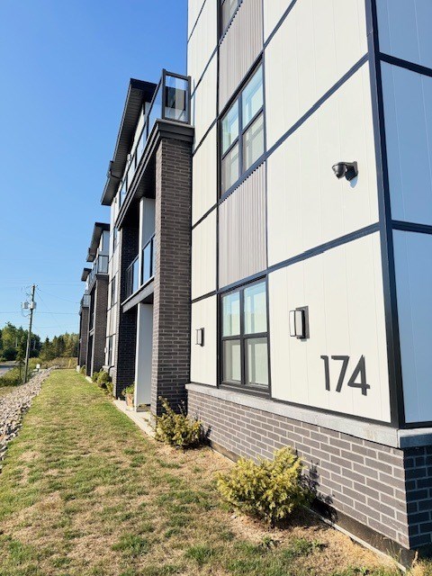 A modern building with the number 174 on the side.