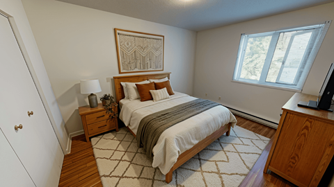 A bedroom with a bed, nightstand, and a painting on the wall.