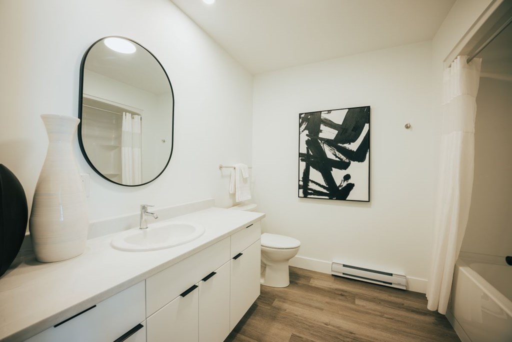 A bathroom with a white sink and toilet.
