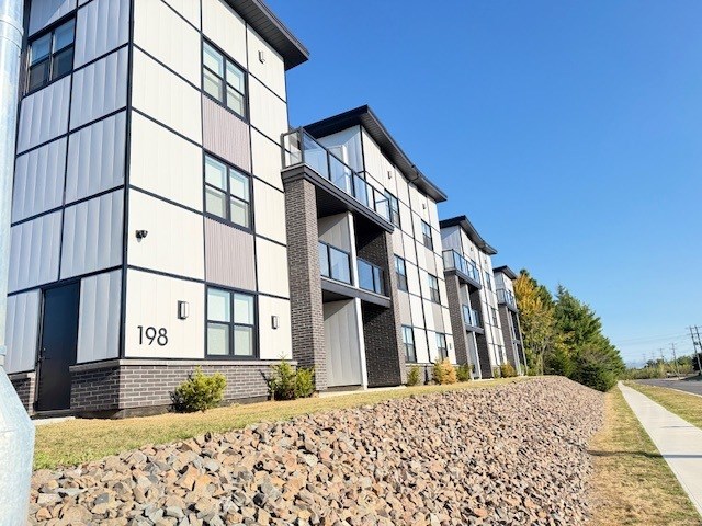 A modern apartment building with the number 198 on the front.