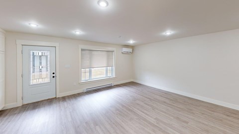 A room with a white door and a window with a white frame.