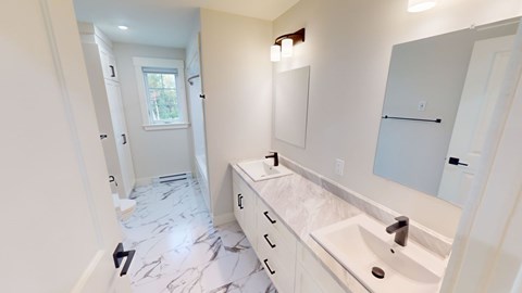 A bathroom with a marble floor and white walls.