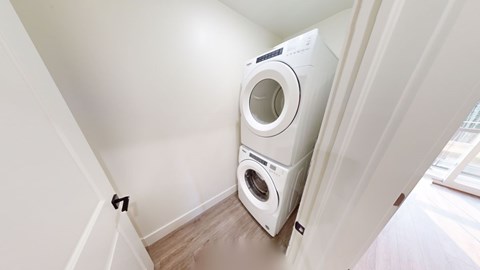 A white washing machine is in a small room.