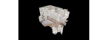 A white, multi-level house with a balcony and a kitchen.