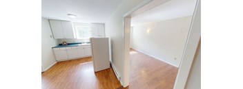 A kitchen with white cabinets and a window.