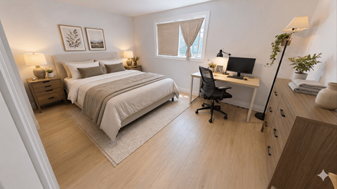 A bedroom with a bed, desk, and chair.