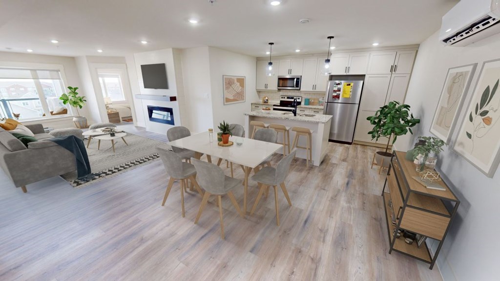 A modern open plan living and kitchen area with a dining table and chairs.