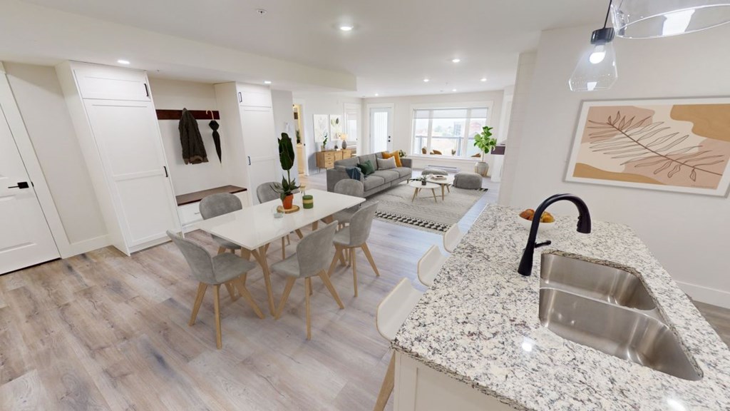 A modern kitchen with a dining table and chairs.