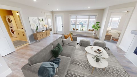 A living room with a grey sofa and a white coffee table.