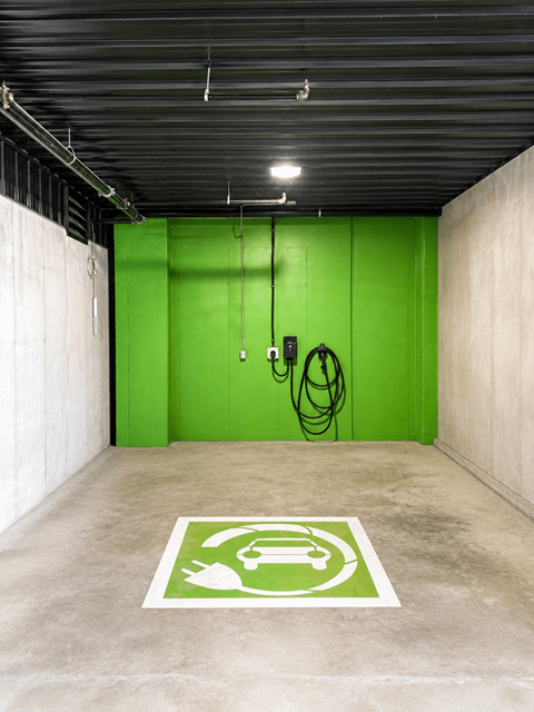 A parking space with a green sign on the floor.