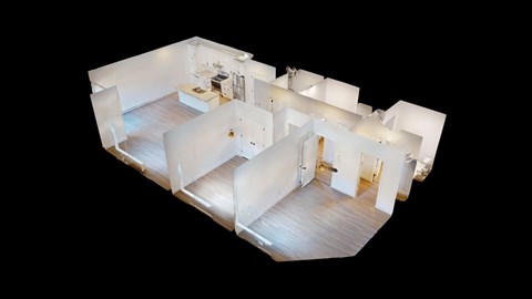 A white modern house with a kitchen, living room, and bedrooms.