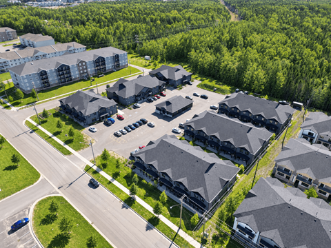 A bird's eye view of a residential area with houses and cars.