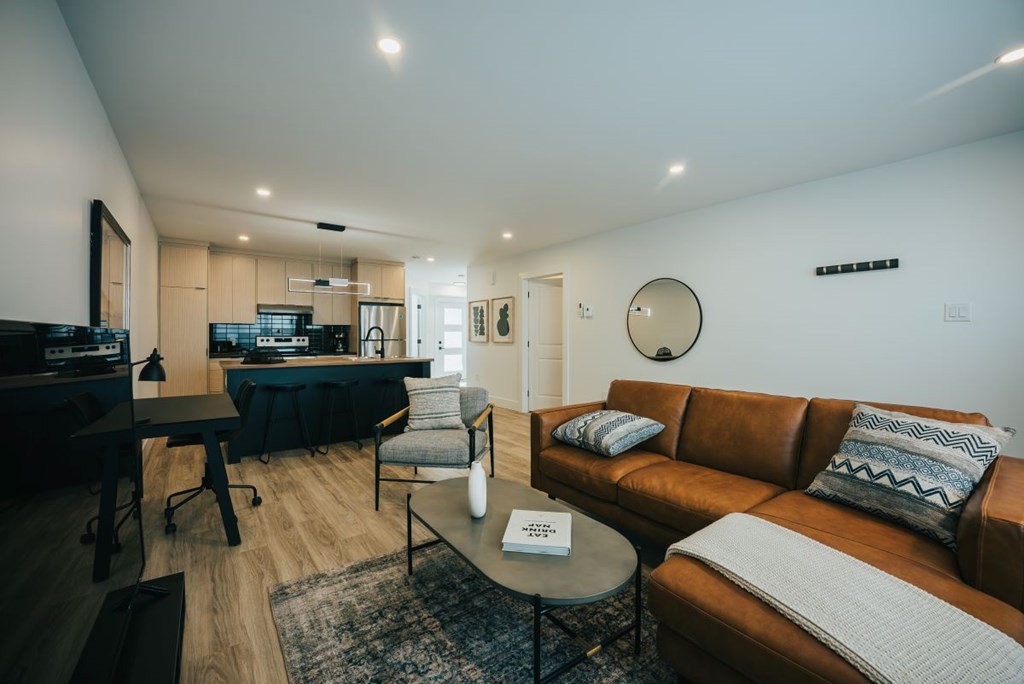 A living room with a brown couch and a coffee table.