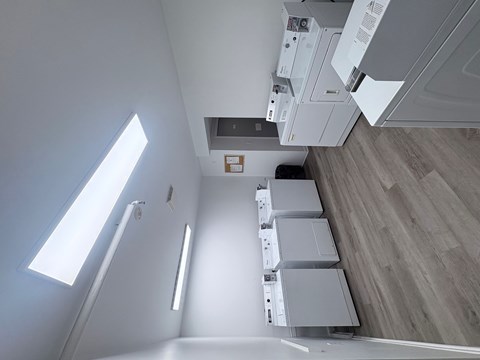 A view of a kitchen with a white cabinet and a white fridge.