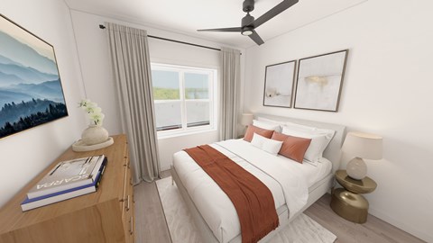 A bedroom with a large bed and a ceiling fan.