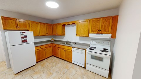 A kitchen with wooden cabinets and white appliances.