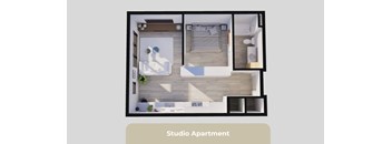 A studio apartment is shown with a bed, a desk, and a kitchenette.