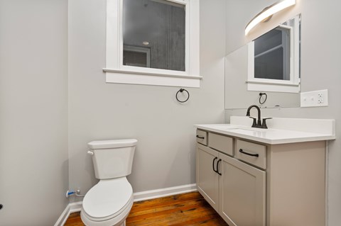 A white toilet sits next to a sink in a bathroom.