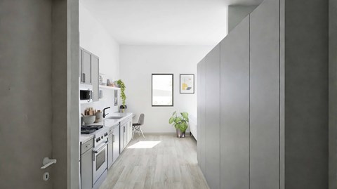 A modern kitchen with a dining area and a potted plant.