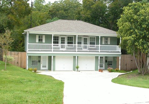 A house with a green roof and white trim.