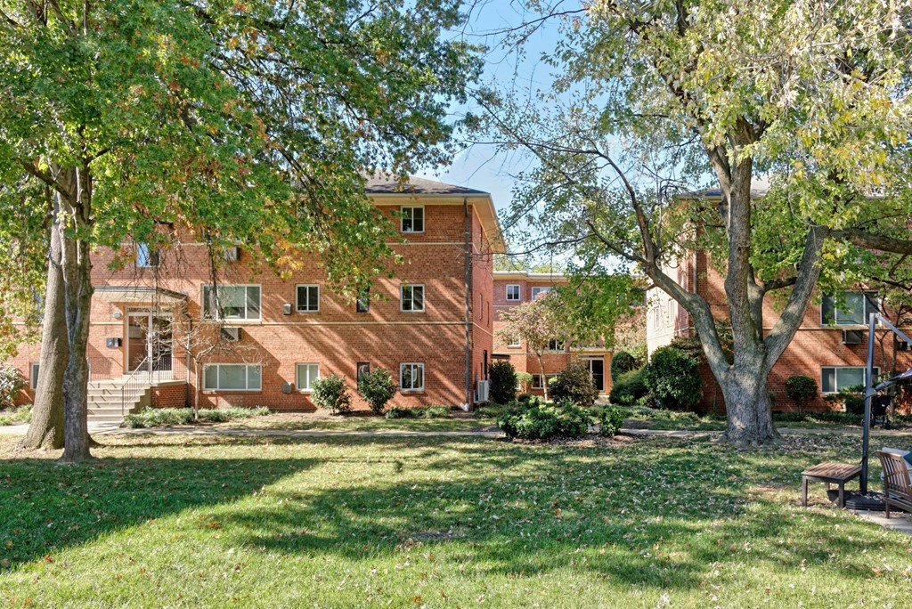 A large red brick building with a tree in front of it.
