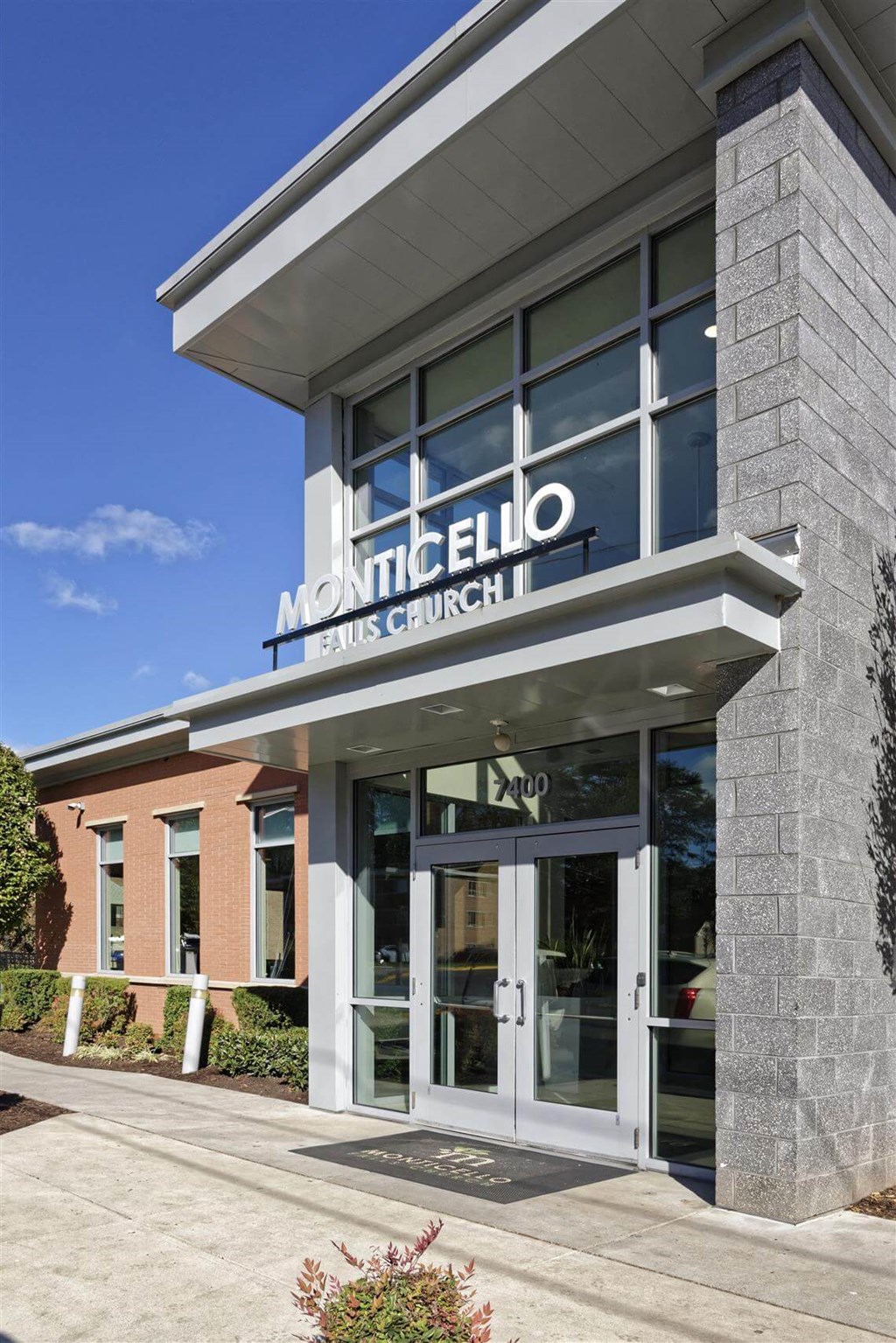 The front of a Monticello French Church with a clear blue sky in the background.