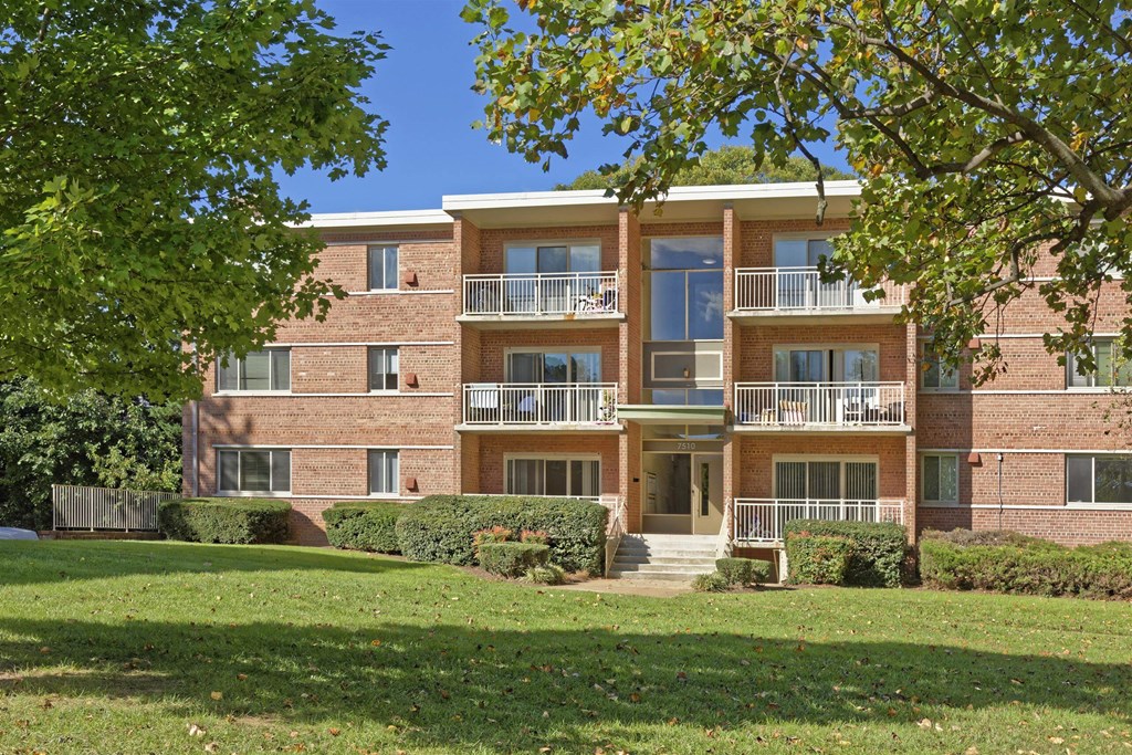 A large brick building with a balcony on the second floor.
