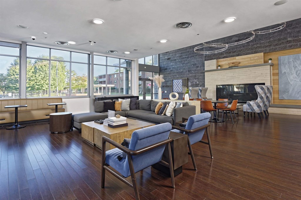 A modern living room with a grey couch and blue chairs.